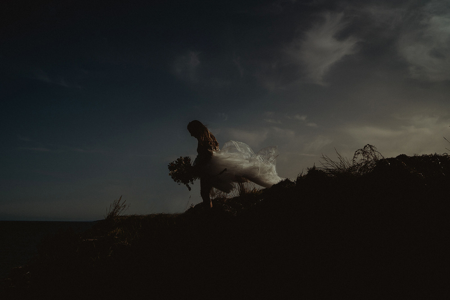 Elopement clifftop walk with tulle dress and wild autumnal wedding bouquet