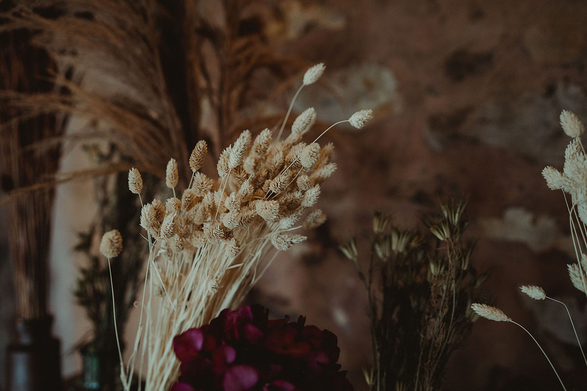 Dried flowers in vases on oil drums with wood tabletop Small Wedding Scotland Inspo