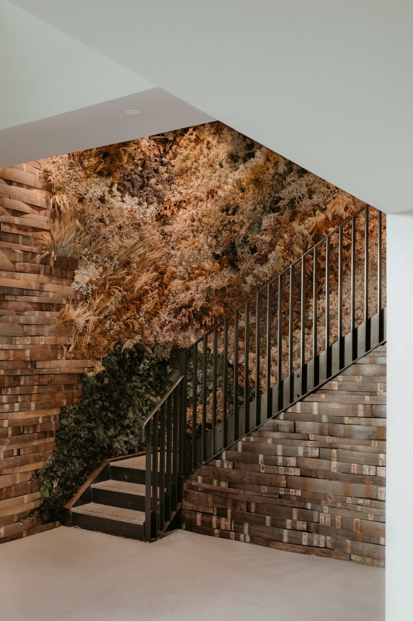 Modern staircase with dried wild floral installation